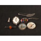 Seven silver brooches, one with enamel decoration, one painted on ivory,