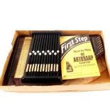A boxed thirty two string autoharp