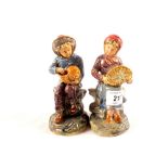 A pair of pottery figures of a fisher boy and girl