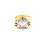 A continental high grade gold set ring with blue stone with abstract design to setting,