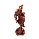 A Chinese hardwood carving of an artisan,