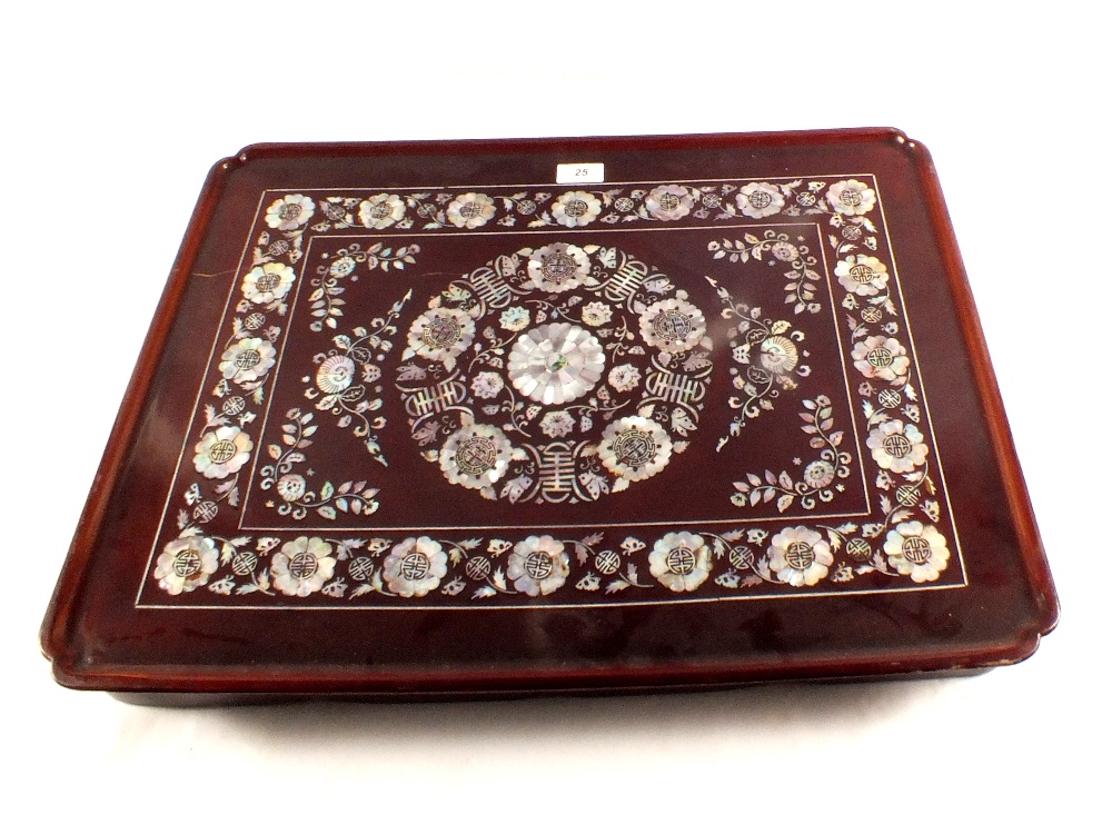 A Chinese folding bed tray with profuse mother of pearl floral decoration