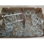 Various cut glass drinking glasses plus a bottle holder