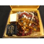 A box containing various costume jewellery plus a small pair of 9ct gold hoop earrings