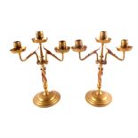 A pair of brass three sconce candelabra