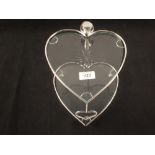 A two tier cut glass and chrome heart shaped cake stand