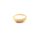 An 18ct gold ring set with five small diamonds,