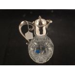 A silver plate cut glass claret jug