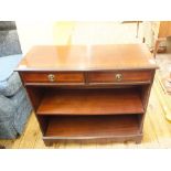 A small mahogany bookcase with two drawers and two pot cupboards