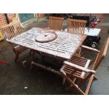 A set of four outdoor chairs and a table with a Lazy Suzy