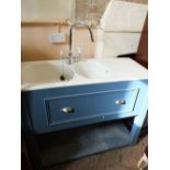 A free standing kitchen unit comprising a double sink with chrome mixer tap on a blue painted pine