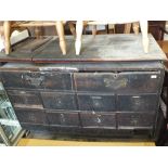 A rustic oak chest of ten drawers with a non-matching top