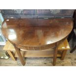 A mahogany D end table on square tapered legs