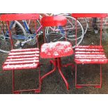 An industrial style adjustable painted chair and two red painted folding chairs