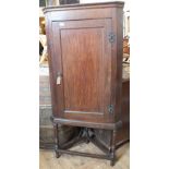 A 19th Century oak corner cupboard on a stand