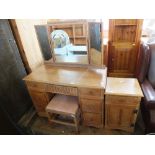 A limed oak dressing table with nine drawers,