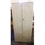 A 19th Century white painted pine corner cupboard with two upper and two lower doors
