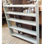 A narrow painted pine bookshelf with five shelves