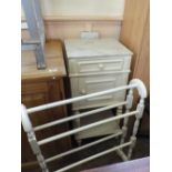 A marble top bedside cabinet and a towel rail