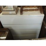 A white painted chest of five long drawers