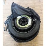 A Mercedes Benz space saver spare wheel in case,