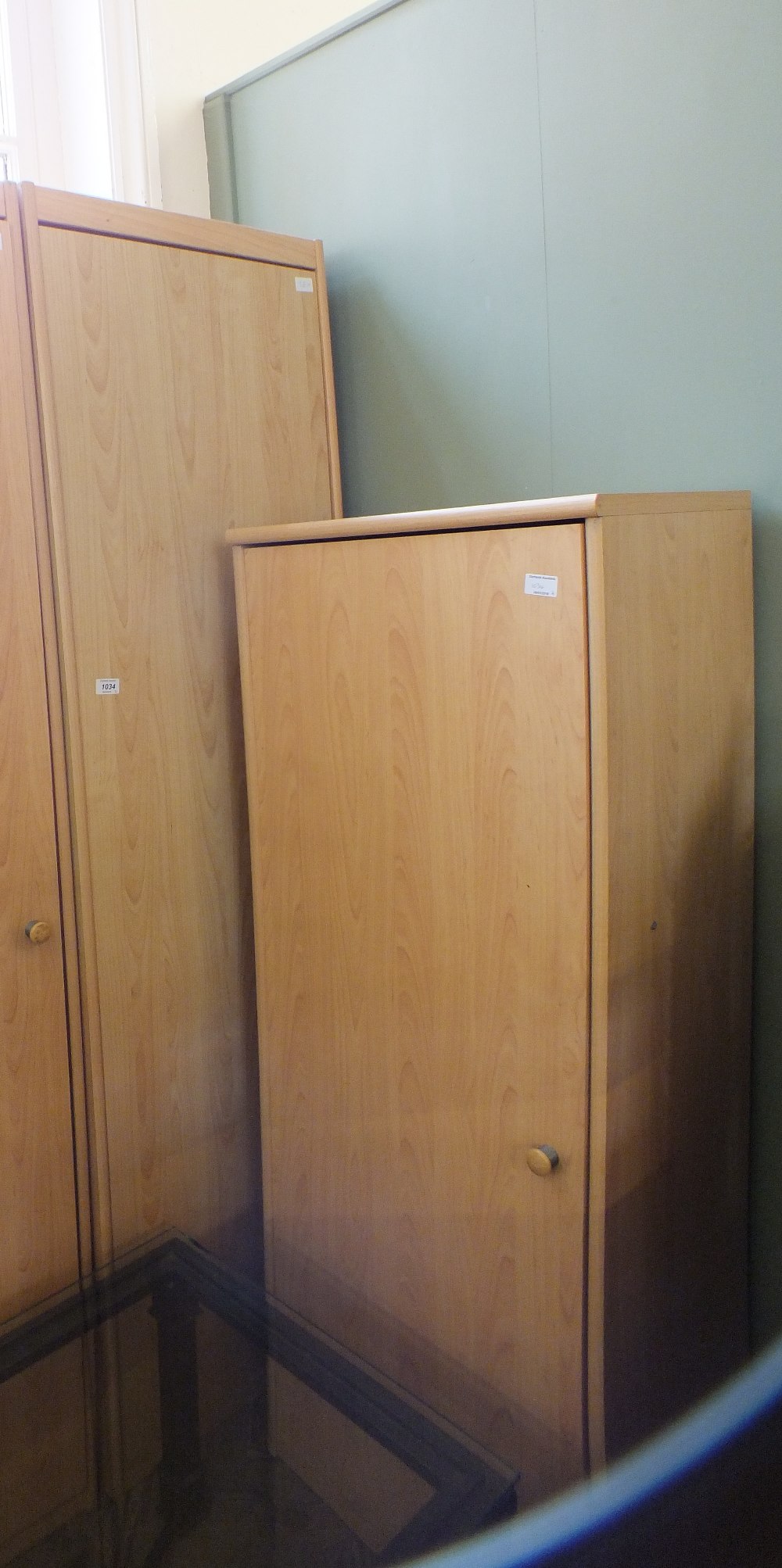 A large pine effect single door wardrobe (height 76") and a smaller pine effect single door