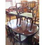 A reproduction dining table and set of six dining chairs with rope backs including two carvers