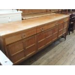 A Nathan Danish style teak sideboard with three drawers and four doors,