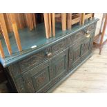 A painted oak two door, two drawer sideboard with rubbed edges,