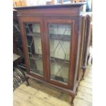 A mahogany cross banded lead glazed two door display cabinet on legs and a bow fronted mahogany