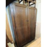 A 1920's oak two door wardrobe