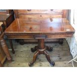 A beautiful rosewood card table on quatrefoil base on brass castors