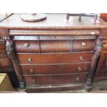 A Scottish mahogany chest of seven shaped drawers with frieze top drawer and carved grape columns,