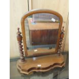 A mahogany swing toilet mirror on barley twist supports