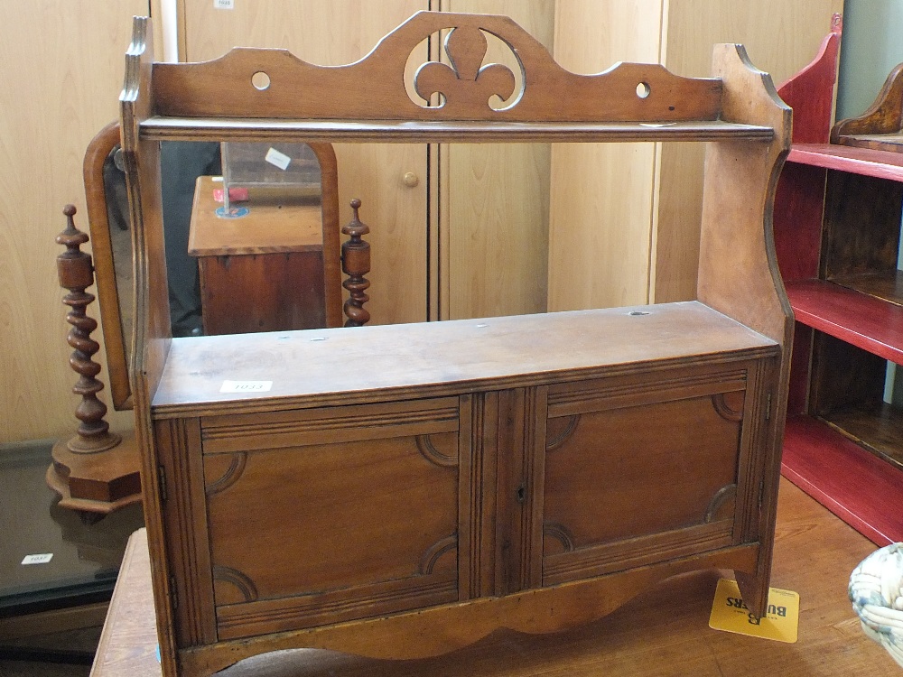 A mahogany wall hanging two door cupboard and two other wall hanging shelves