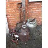 Two milk churns, a large wooden spade,