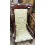 A 19th Century mahogany nursing chair with scroll arms and gold upholstered back and seat