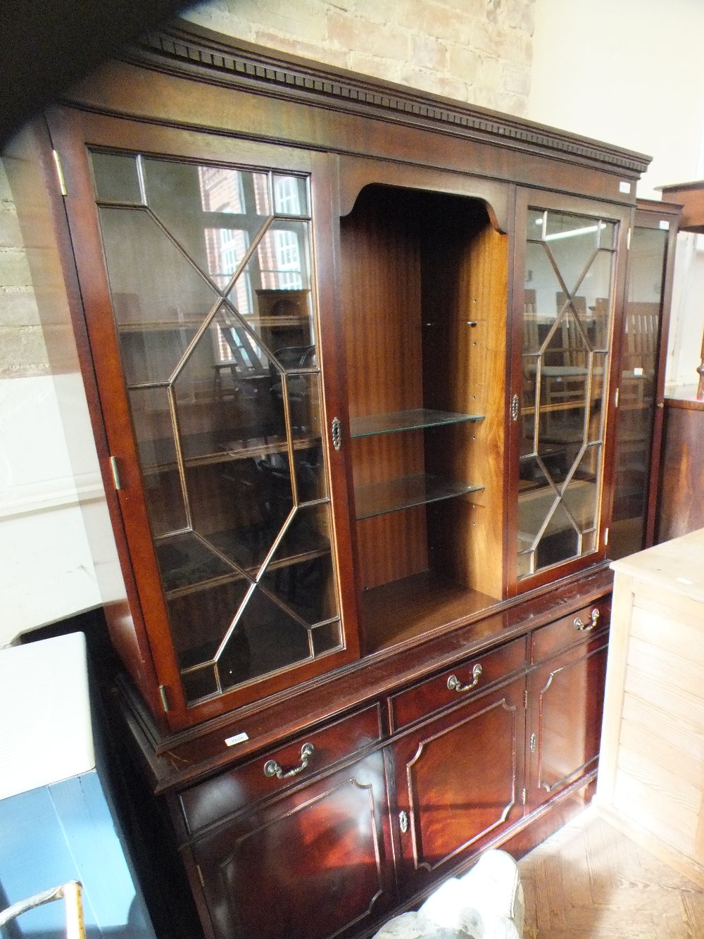 A reproduction astral glazed cupboard bookcase