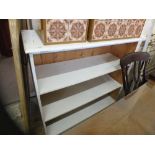 A white painted pine bookcase with three shelves,