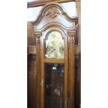 A modern oak cased long case clock with brass dial and ship roller