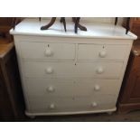 A white painted pine chest of two short and three long drawers