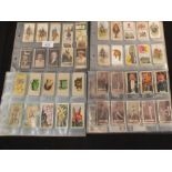 Cigarette cards in album leaves