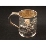 A silver tankard with embossed rural scene decoration,
