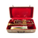 A cased Chinese brass trumpet