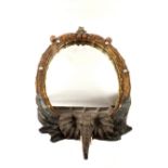 A plaster wall mirror with elephant decoration