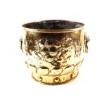 A large 19th Century Dutch embossed brass jardiniere/log bucket with gadrooning and lion mask ring