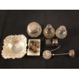 Three silver top jars, two serviette rings,