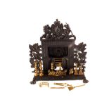A cast iron miniature fire place plus irons and candlesticks etc