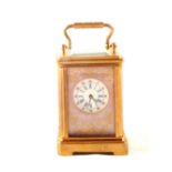 A miniature brass carriage clock with painted porcelain panels