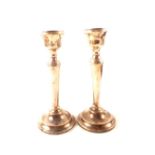 A pair of silver candlesticks (dented)